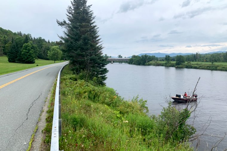 Fish and Game officers search the Connecticut River in Lancaster, N.H.