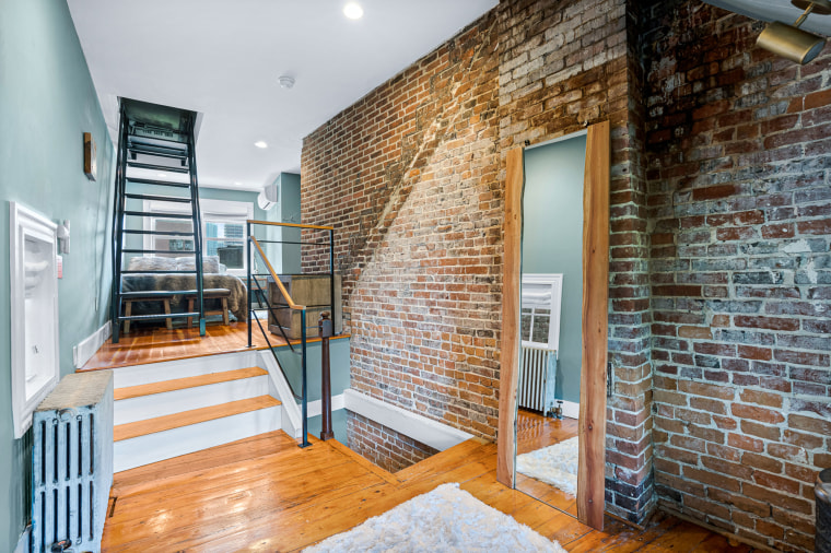 The large bedroom features a custom closet and lighting. The room also has direct access to the roof deck. 