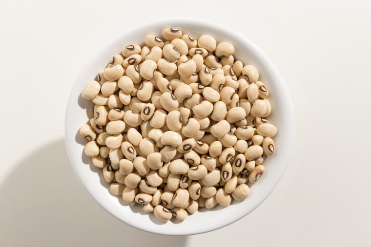 Close-Up Of Beans In Bowl Against White Background