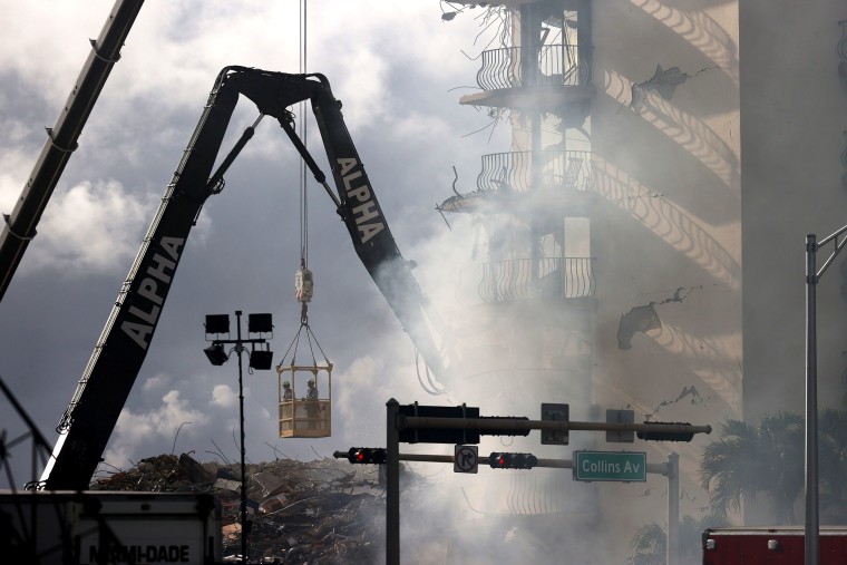 Image: Search and rescue crews work to find survivors at the site of the collapse on June 26, 2021.