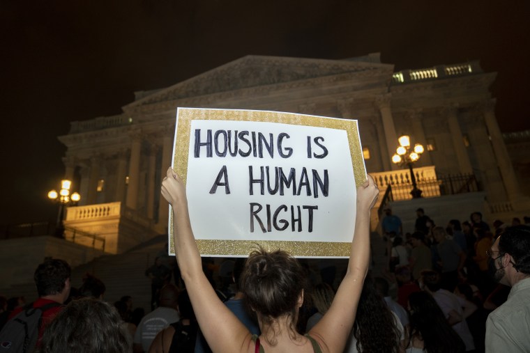 Image: Demonstrators gather during a protest on expiration of eviction moratorium