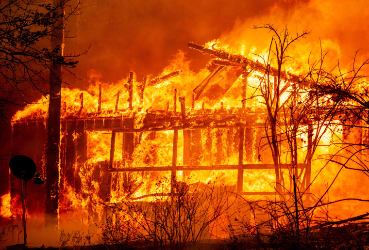 A home is engulfed in flames as the Dixie fire rages in Greenville, Calif., on Aug. 5, 2021.