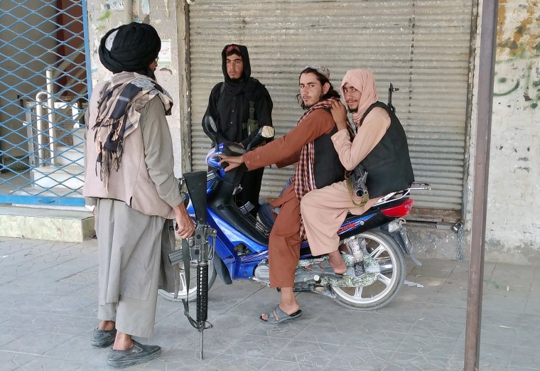 Image: Taliban fighters patrol inside the city of Farah, capital of Farah province southwest of Kabul, Afghanista