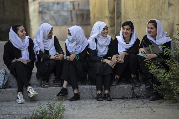 Image: Afghan female students talk after school outside the Zarghoona high school