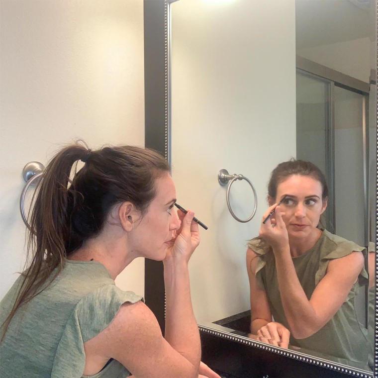 Writer Katie Jackson using the Anastasia Brow Pen while looking in the mirror