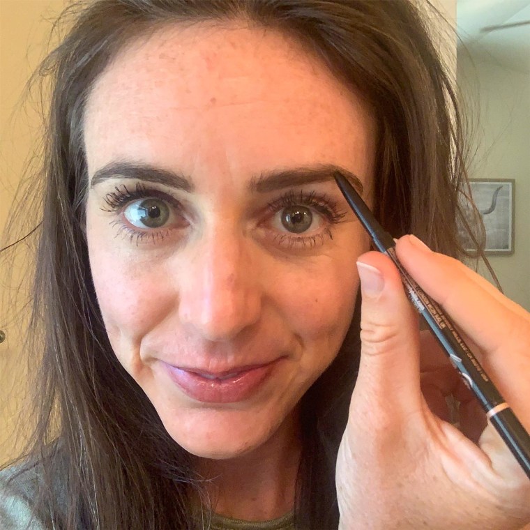 Close up image of Writer Katie Jackson coloring in her eye brows with the Anastasia Brow Pen