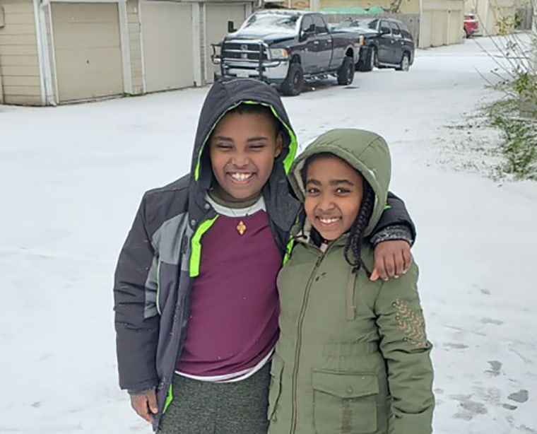 Shalemu Bekele's children, Beimnet, left, and Rakaeb enjoy the snow on the morning of Feb. 15.