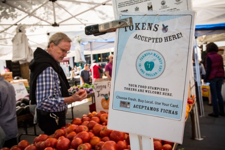 Image: A sign displays that a shop accepts Electronic Benefits Transfer, more commonly known as Food Stamps, in the GrowNYC Greenmarket in Union Square