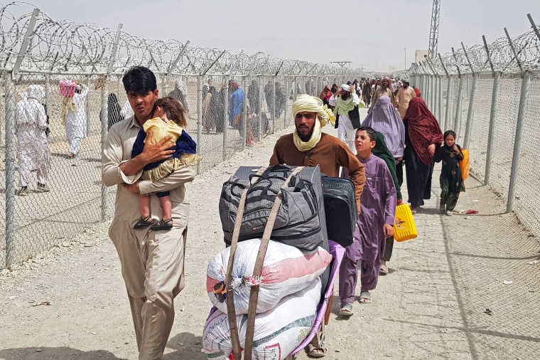 Stranded Afghan nationals arrive to return back to Afghanistan at the Pakistan-Afghanistan border crossing point in Chaman on Aug. 16, 2021.