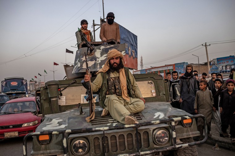 Taliban fighters on a Humvee in Kabul on Aug. 15, 2021.