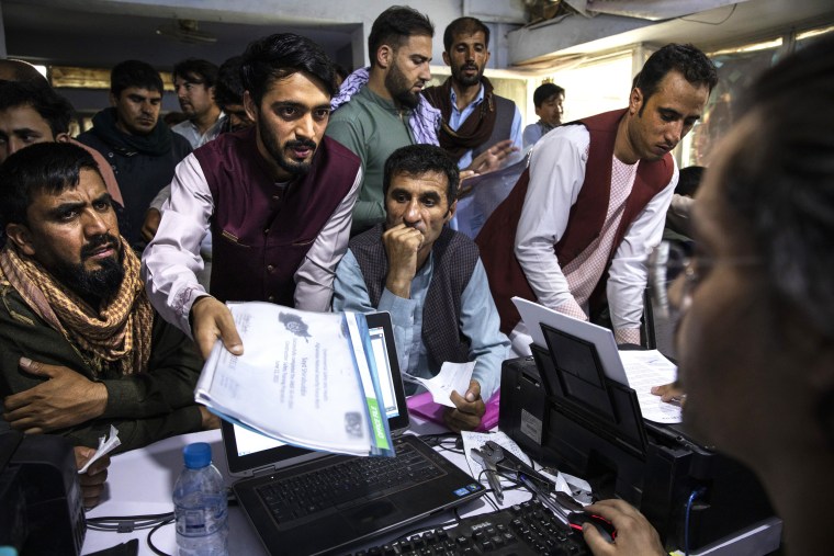 Afghans crowd into the Herat Kabul Internet cafe seeking help applying for Afghan Special Immigrant Visas on Aug. 8, 2021, in Kabul.