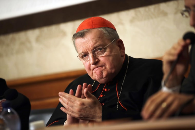 Cardinal Raymond Burke applauds during a press conference at the Italian Senate in Rome on Sept. 6, 2018.