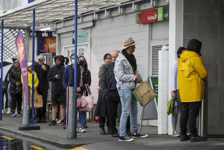 Image: Shoppers lineup to enter a supermarket in Auckland, New Zealand,