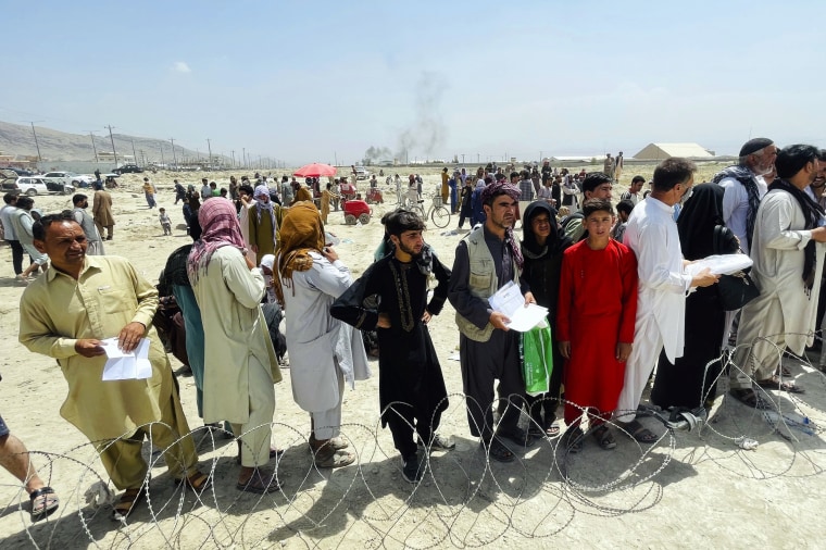 Hundreds of people gather outside the international airport in Kabul, Afghanistan, on Aug. 17, 2021.