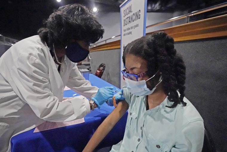 A nurse gives Ayana Campbell, 14, a dose of the Pfizer vaccine at Jackson State University in Jackson, Miss., on July 27, 2021.