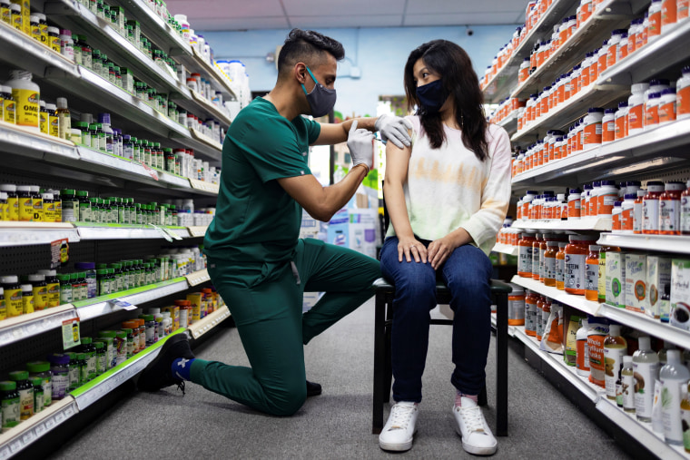 A woman receives a Pfizer Covid-19 vaccination as a booster dose at Skippack Pharmacy in Schwenksville, Pa., on Aug, 14, 2021.
