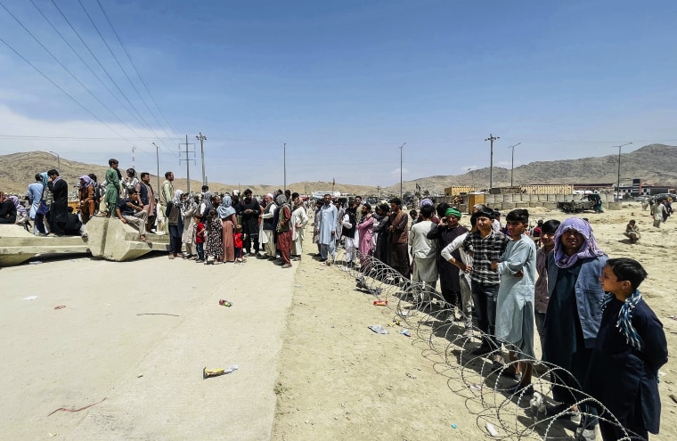 Image: Hundreds of people gather outside the international airport in Kabul, Afghanistan on Aug. 17, 2021.