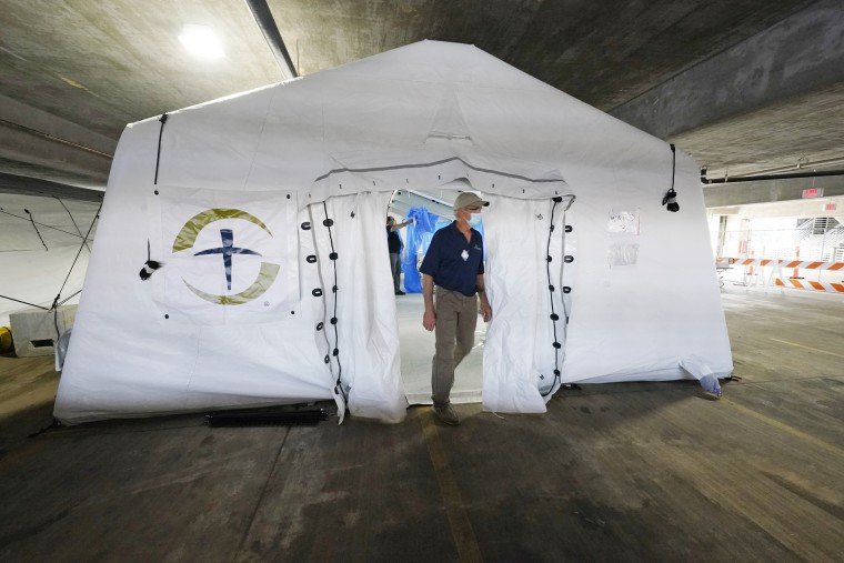 A Samaritan's Purse staff member walks out of one of the four wards at an emergency field hospital at a University of Mississippi Medical Center's parking garage on Aug. 17, 2021, in Jackson.