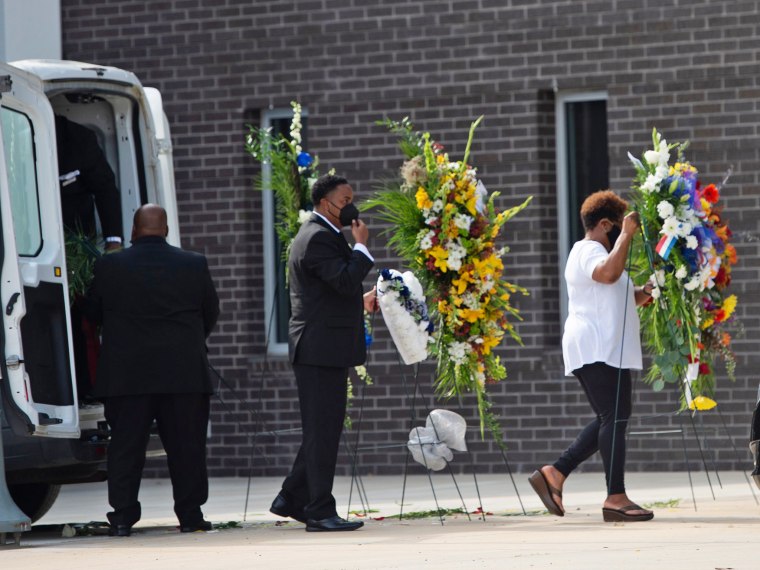 Flowers for the funeral service of Hinds County Sheriff Lee Vance arrive at the Mississippi Coliseum on Aug. 14, 2021. Vance died on Aug. 4 from cardiorespiratory failure as a result of Covid-19.