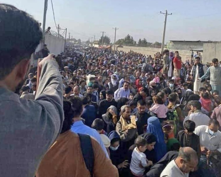 IMAGE: Afghans hoping to be evacuated gather at the airport in Kabul