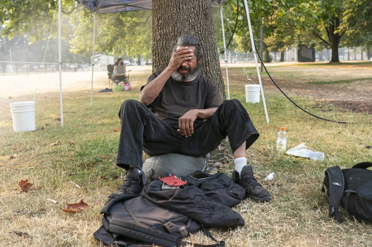 Image: A homeless man near a misting station in Portland, Ore.