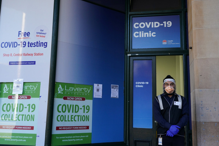 Image: A staff member stands at the entrance of a Covid19 clinic during a lockdown to curb a coronavirus disease outbreak in Sydney