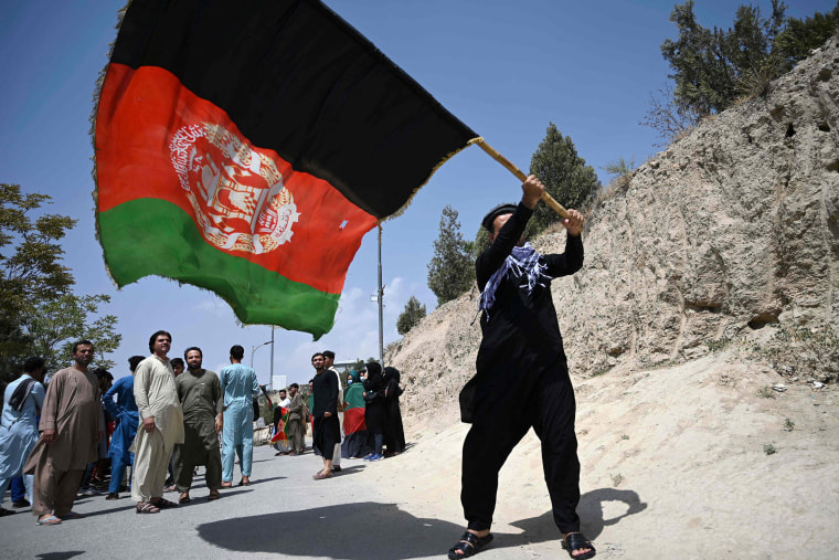 Image: An Afghan waves the national flag as they celebrate the 102th Independence Day of Afghanistan in Kabul on Saturday.