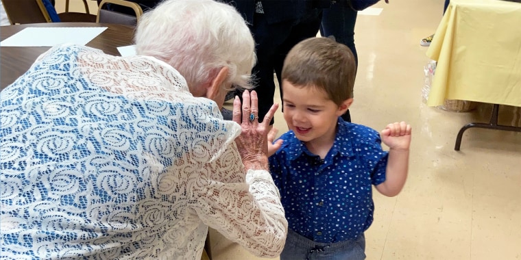 Benjamin Olson, 2, helps his best friend and neighbor Mary O'Neill celebrate her 100th birthday.