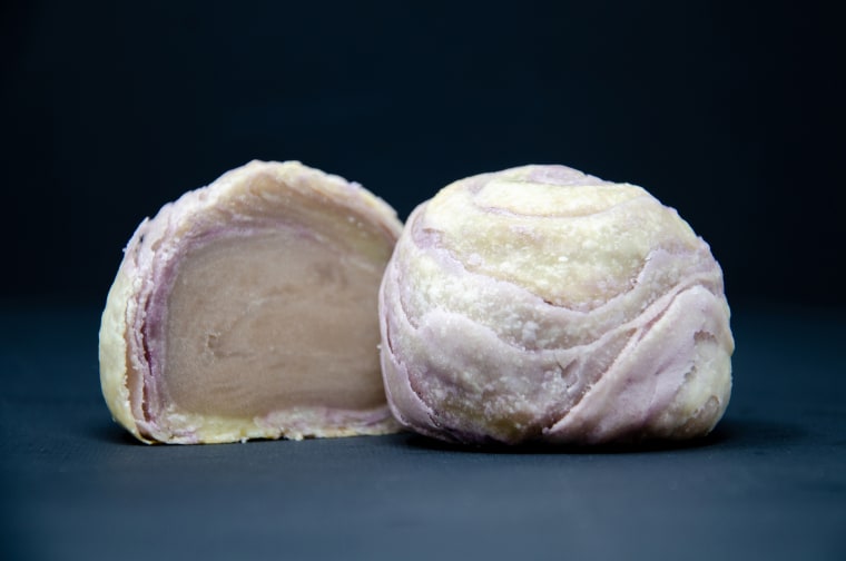 Photo of two round shaped foods on dark background