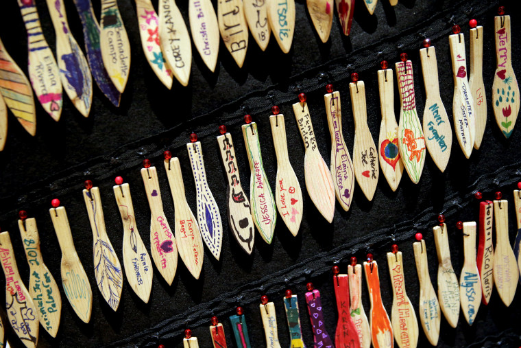 Image: Small, wooden paddles with the names of missing and murdered indigenous women on a garment at a memorial vigil at the University of Washington in Seattle on Feb. 14, 2019.