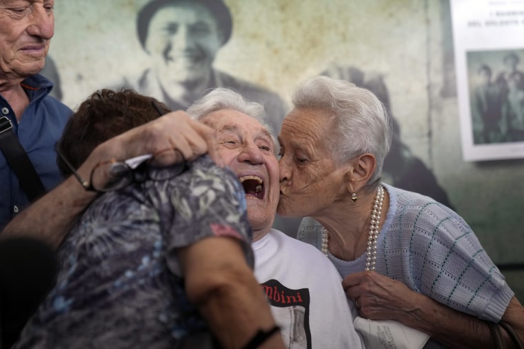 Image: Martin Adler, a 97-year-old retired American soldier, center, receives a kiss from Mafalda, right, and Giuliana Naldi, whom he saved during WWII