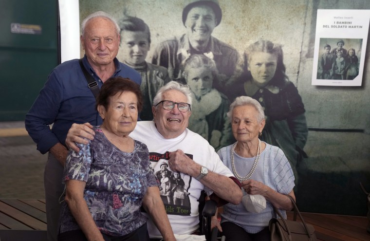 Image: Retired American soldier Martin Adler, center, poses with Giulio, left, Mafalda, right, and Giuliana Naldi at Bologna airport on Monday.