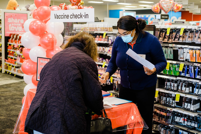 Image: A worker checks in a person with an appointment to receive a dose of the Moderna Covid-19 vaccine at a CVS Pharmacy location in Eastchester, N.