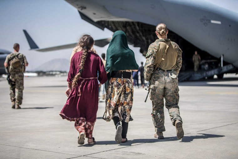 Image: A Marine with the 24th Marine Expeditionary Unit (MEU) walks with the children during an evacuation at Hamid Karzai International Airport, Kabul, Afghanistan, on Aug. 24, 2021.