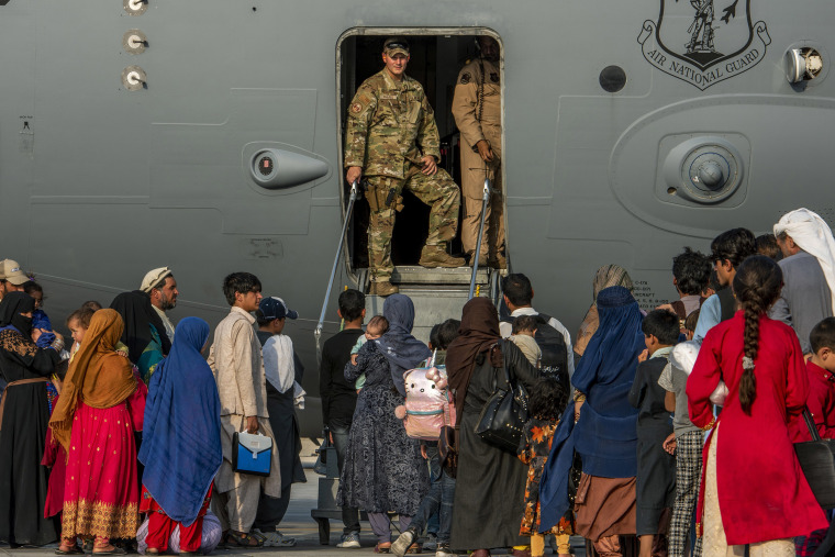 Image: Service members prepare to board evacuees onto a C-17 Globemaster lll on Sunday, Aug. 22, 2021, at Al Udeid Air Base, Qatar.