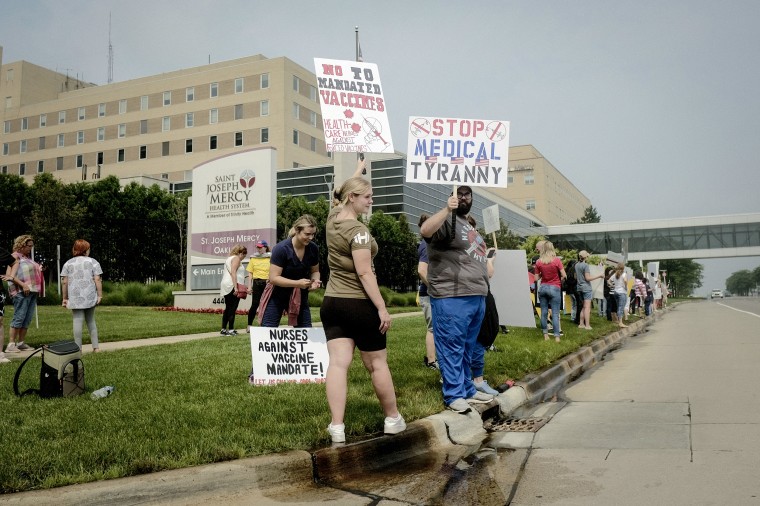 Protesters holding placards expressing their opinion