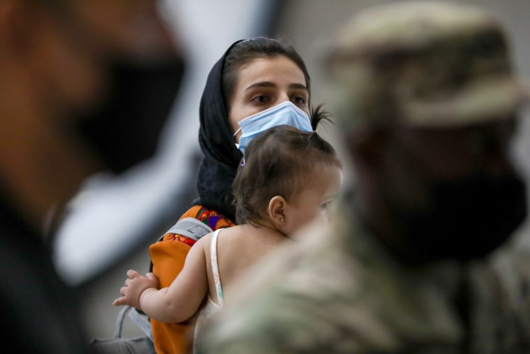 Afghan refugees families evacuated from Kabul arrive in Washington Dulles International Airport