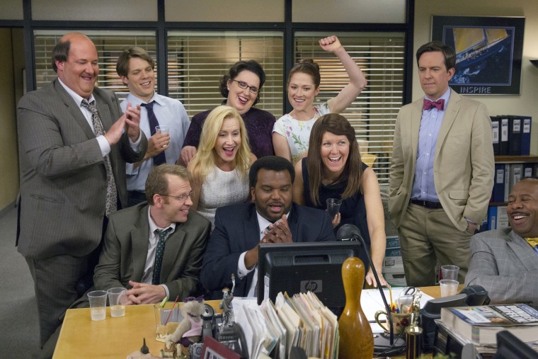Pictured: (l-r) Brian Baumgartner as Kevin Malone, Jake Lacy as Pete, Paul Lieberstein as Toby Flenderson, Angela Kinsey as Angela Martin, Phyllis Smith as Phyllis Vance, Craig Robinson as Darryl Philbin, Ellie Kemper as Erin Hannon, Kate Flannery as Mere