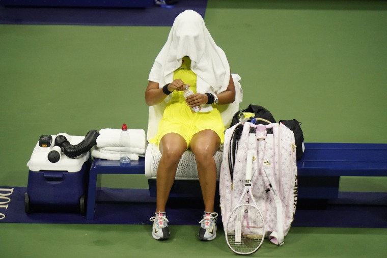 Naomi Osaka, of Japan, covers her head between games against Leylah Fernandez, of Canada, at the third round of the US Open tennis championships, Friday, Sept. 3, 2021, in New York.