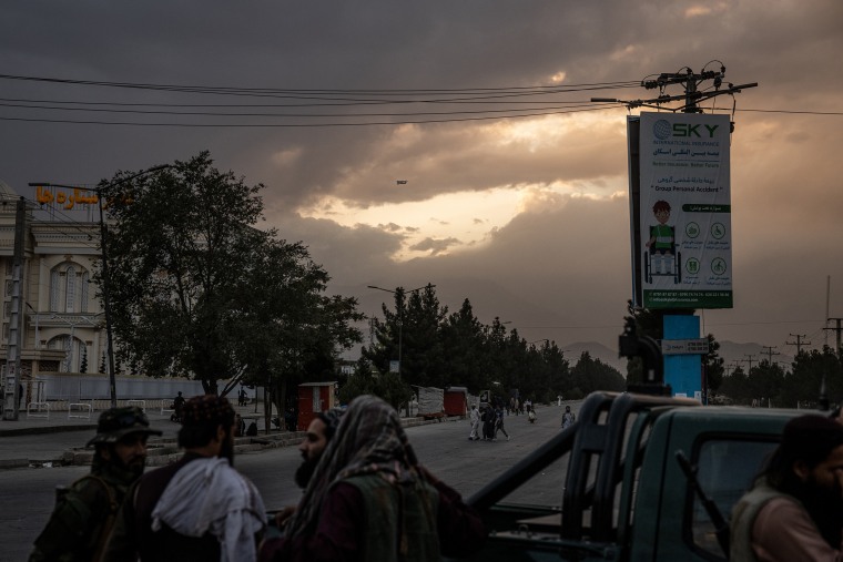 A C-17 military transport plane takes off into the sunset as Taliban forces are stationed outside the airport in Kabul, Afghanistan on Aug. 30, 2021.