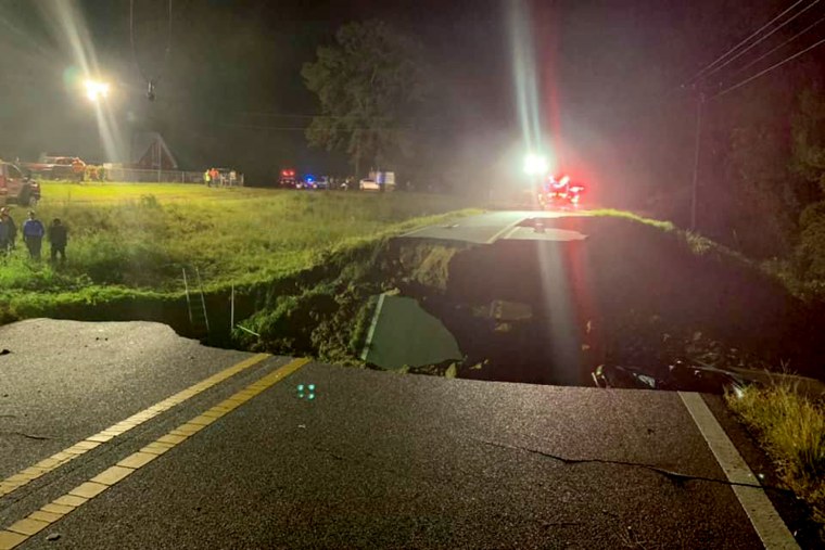 Emergency crews at the scene of a road collapse in George County, Miss., on Tuesday. 