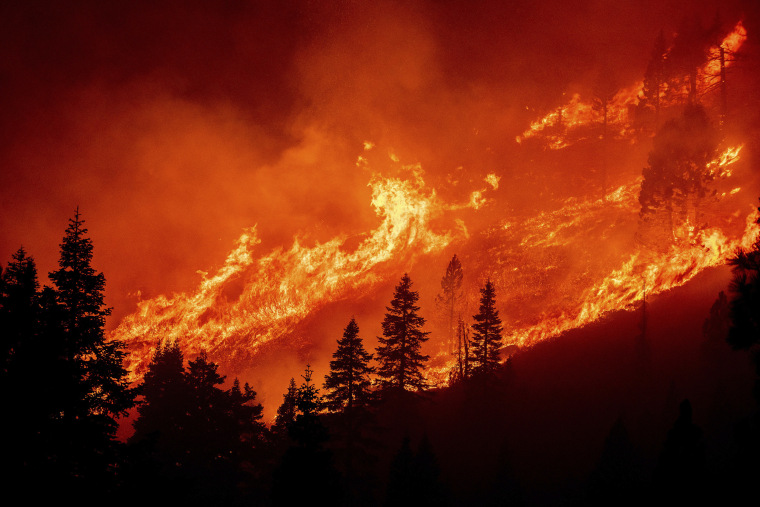 Image: Seen from South Lake Tahoe, Calif., flames from the Caldor Fire leap along a hillside above Christmas Valley.