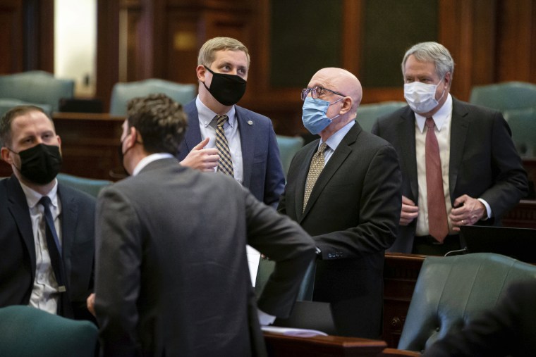 Lawmakers speak prior to the start of a House Rules Committee Hearing at the Illinois State Capitol in Springfield, Ill., on February 10, 2021.