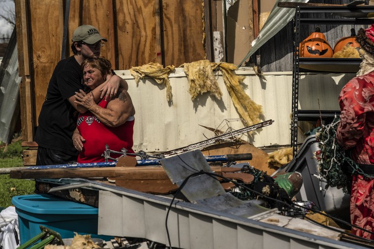 Homeowner Alzile Marie Hand, 66, right, is comforted by her son Thomas James Hand, 19, outside of their damaged house after Hurricane Ida passed through in Houma, La., on Aug. 30, 2021.