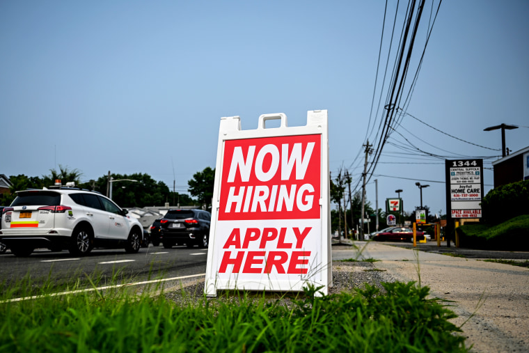 A hiring sign stands along the road in Selden, N.Y., on July 20, 2021.