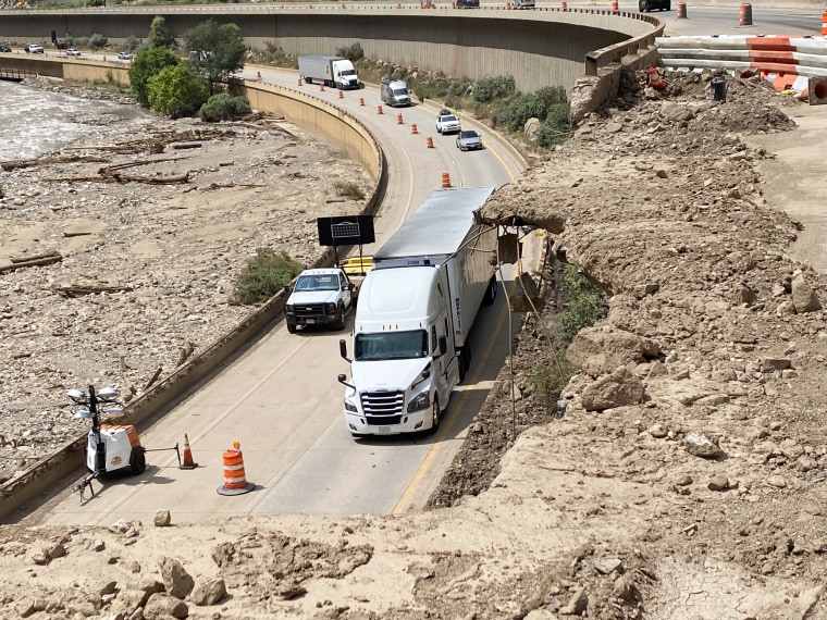 Image: Vehicles move past Glenwood Canyon Mile Marker 123.5, near where a mudslide caused a hole by destroying the parapet of the westbound freeway.