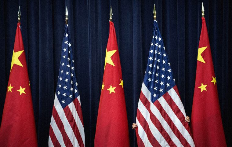 Image: A staff member adjusts an American flag before a U.S. and China Strategic and Economic Dialogue in Washington in 2013.