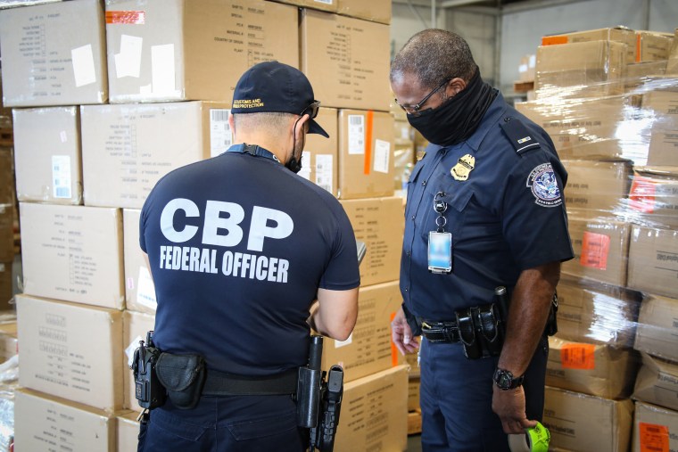 CBP officers in Atlanta inspect apparel suspected to be made with cotton harvested by forced labor in China's Xinjiang Region, August 2021.