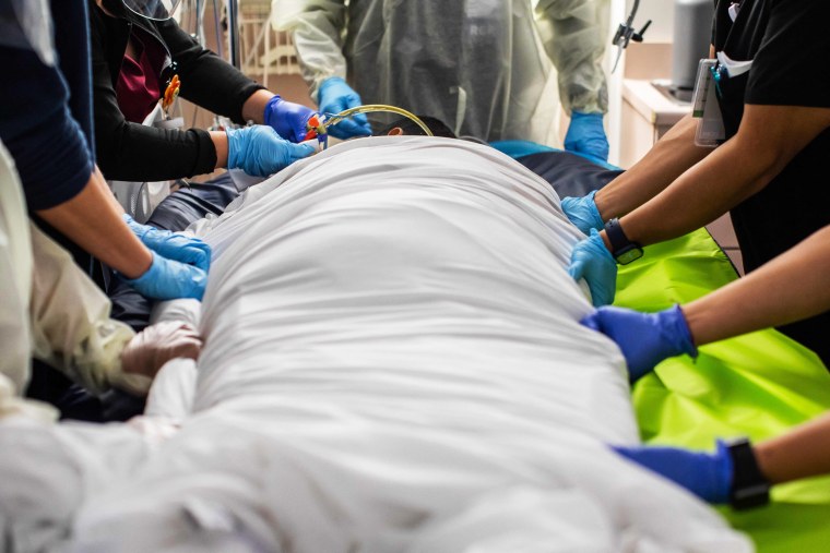 Health care workers attend a patient with Covid-19 at the Cardiovascular Intensive Care Unit at Providence Cedars-Sinai Tarzana Medical Center in Tarzana, Calif., on Sept. 2, 2021.