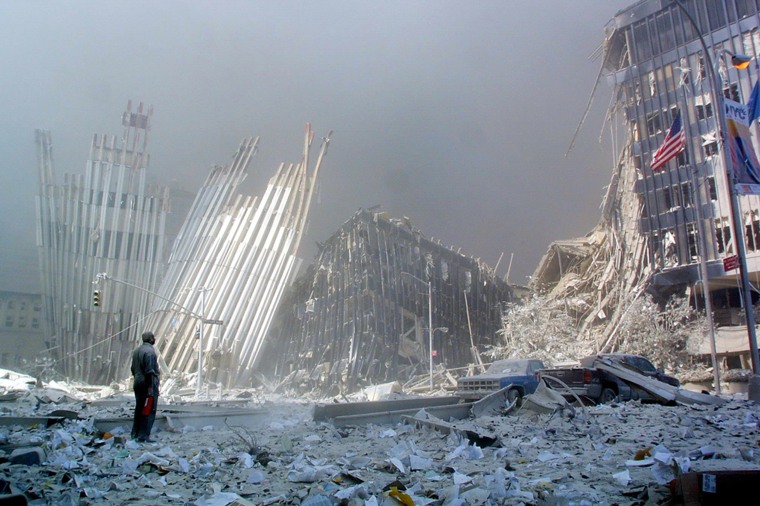 A man stands in the rubble and calls out, asking if anyone needs help, after the collapse of the first World Trade Center Tower.